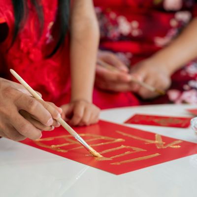 Children and an adult practicing writing.