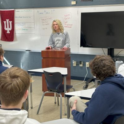 Person giving a presentation at a podium.
