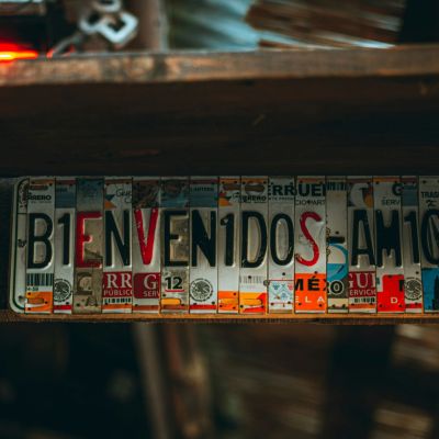 License plates cut up to form the word Bienvenidos Amigos.