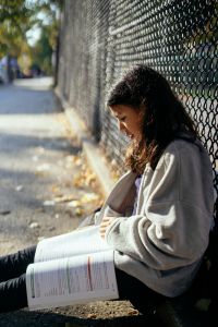 Girl sitting outside and studying.