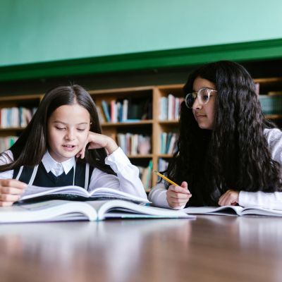 Two girls studying in the library.