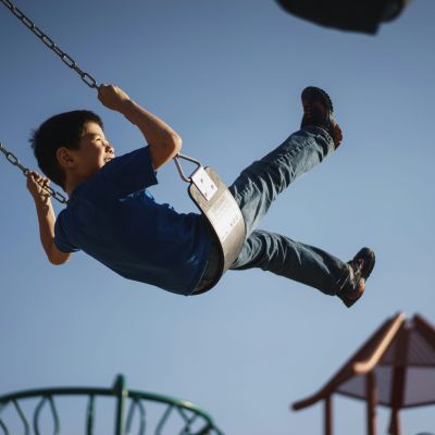 Child swinging on a swing.