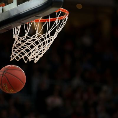 Basketball under the hoop.
