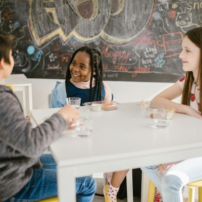 Children sitting at a table together.