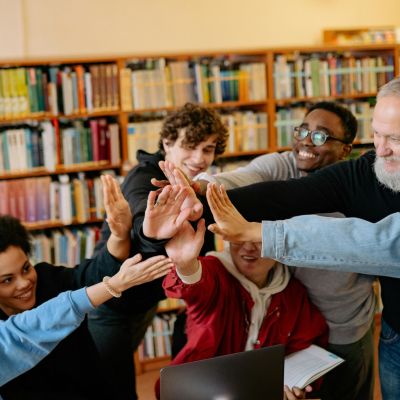 Students giving high fives with a teacher.