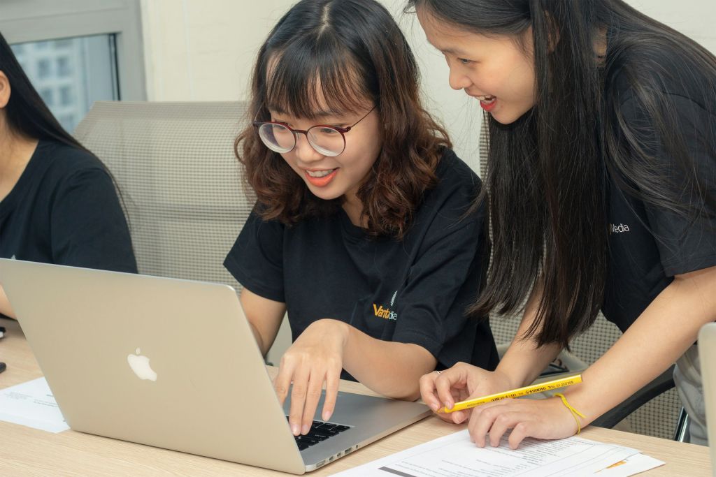 Students working on a laptop together.