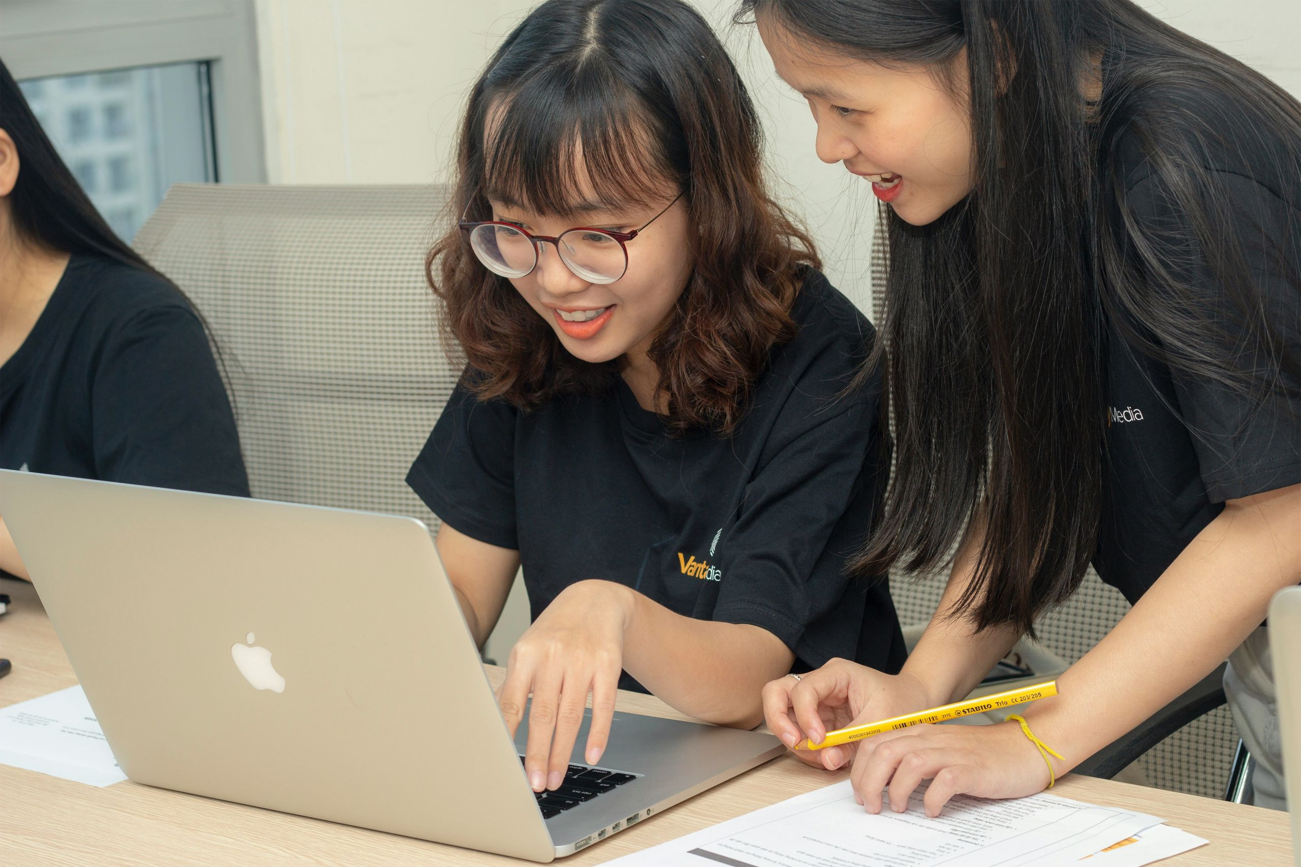 Students working on a laptop together.