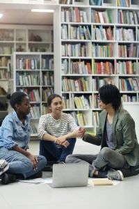 People talking in a library.